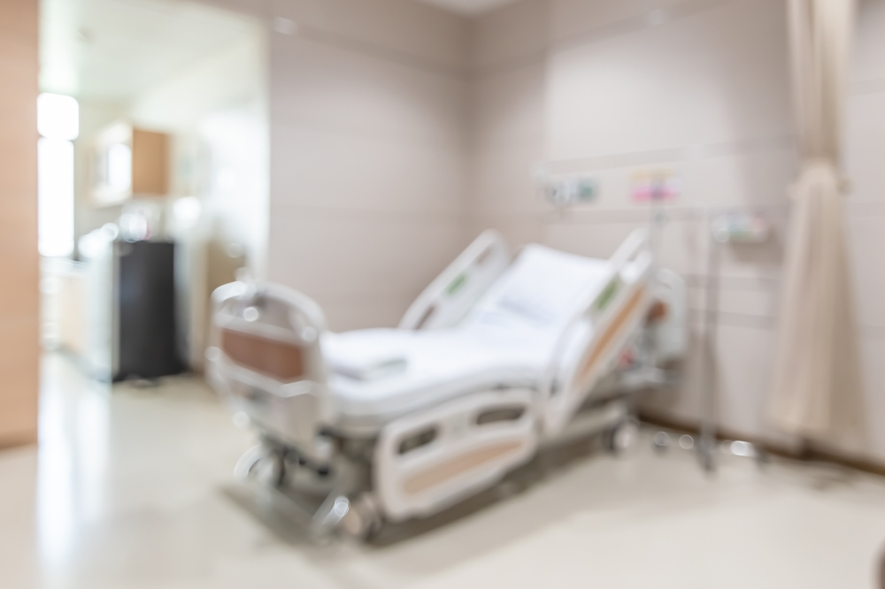 Soft-focus view of Options Behavioral Health hospital room with medical bed and equipment